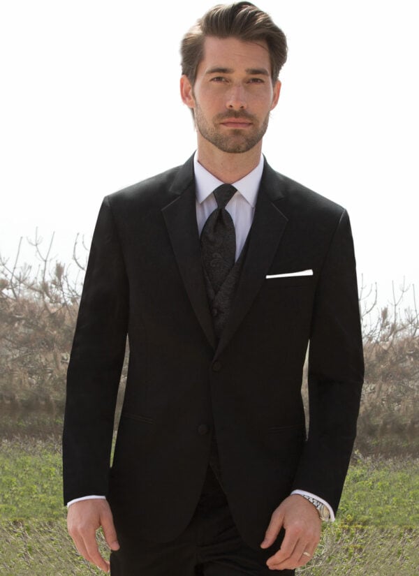 A man poses while wearing the black Desire tuxedo from Michael Kors.