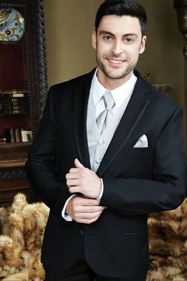 A model wears the black infinity tuxedo with platinum accessories.